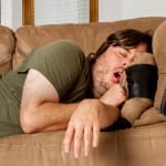 Man taking a quick nap on the couch